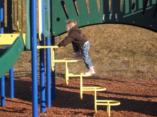 Eve climbing on the playground