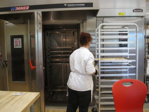 Check out the walk-in oven!  Right next to the oven (behind the rack) is a giant walk-in fridge.