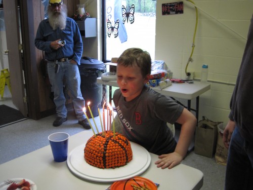 Blowing out the candles!  (the candles are huge and the cake is small.  funny.)