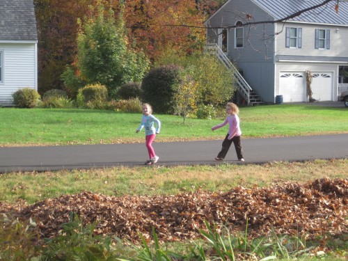 Then they spent some time pretending to walk past the house to see how it looked.  They varied their walking styles and speeds, in case that made a difference in the appearance of the leaf man.  :)